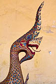 Vientiane, Laos - Wat Si Saket, the wooden trough in the shape of a Naga, used for the  ceremonial cleaning of Buddha statue. 